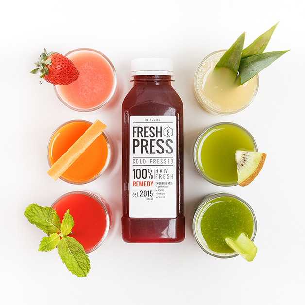 Hero image for mobile showing a Fresh & Press juice named Remedy surrounded by 6 glasses of signature juices