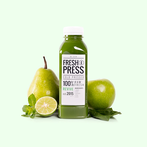 Hero image for mobile showing a Fresh & Press juice named Revive surrounded by ingredients apple, pear, horenzo, lime, mint